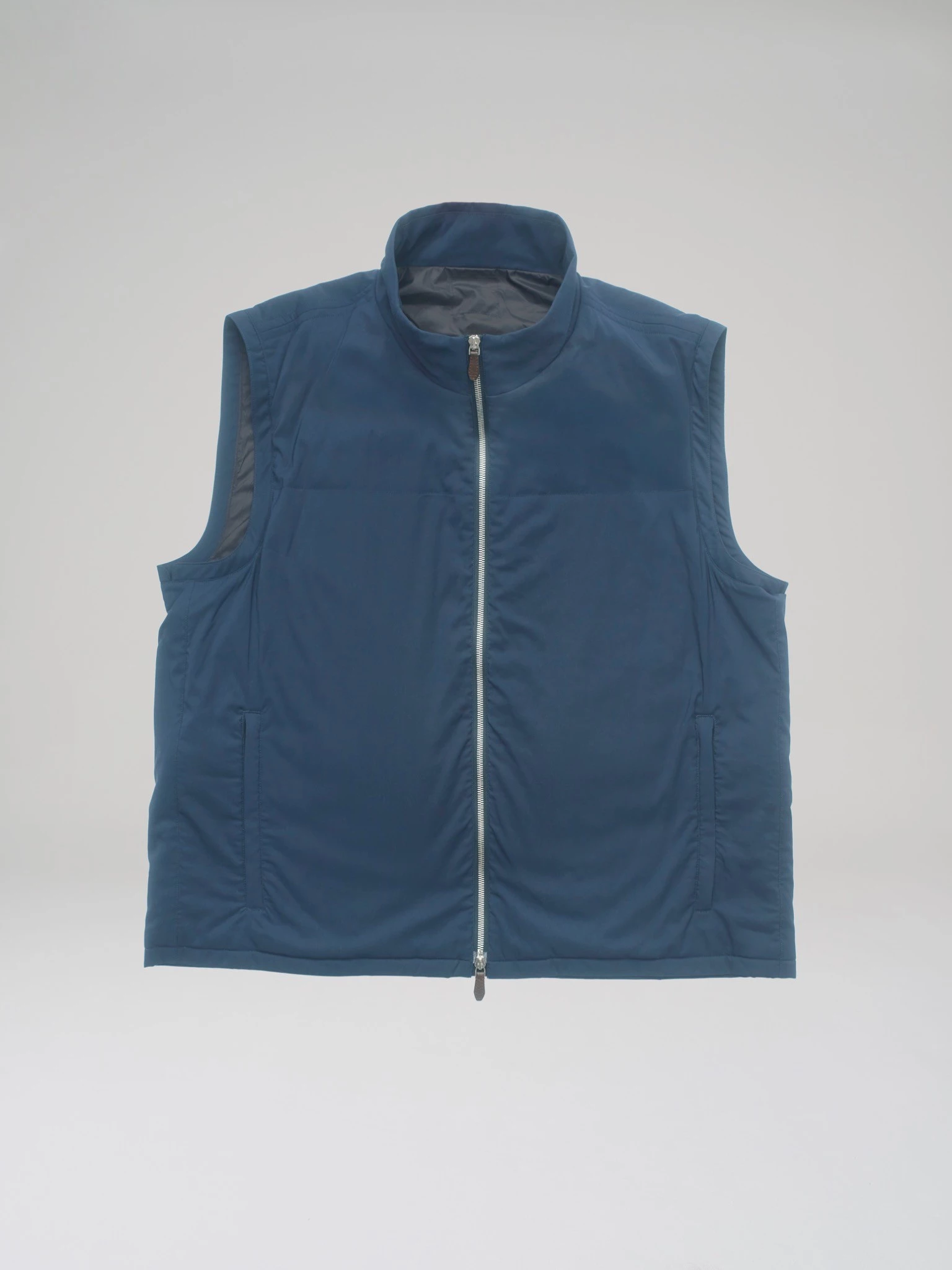Product shot: front view of a blue bulletproof vest made from T-Way fabric in a studio on a light grey background.